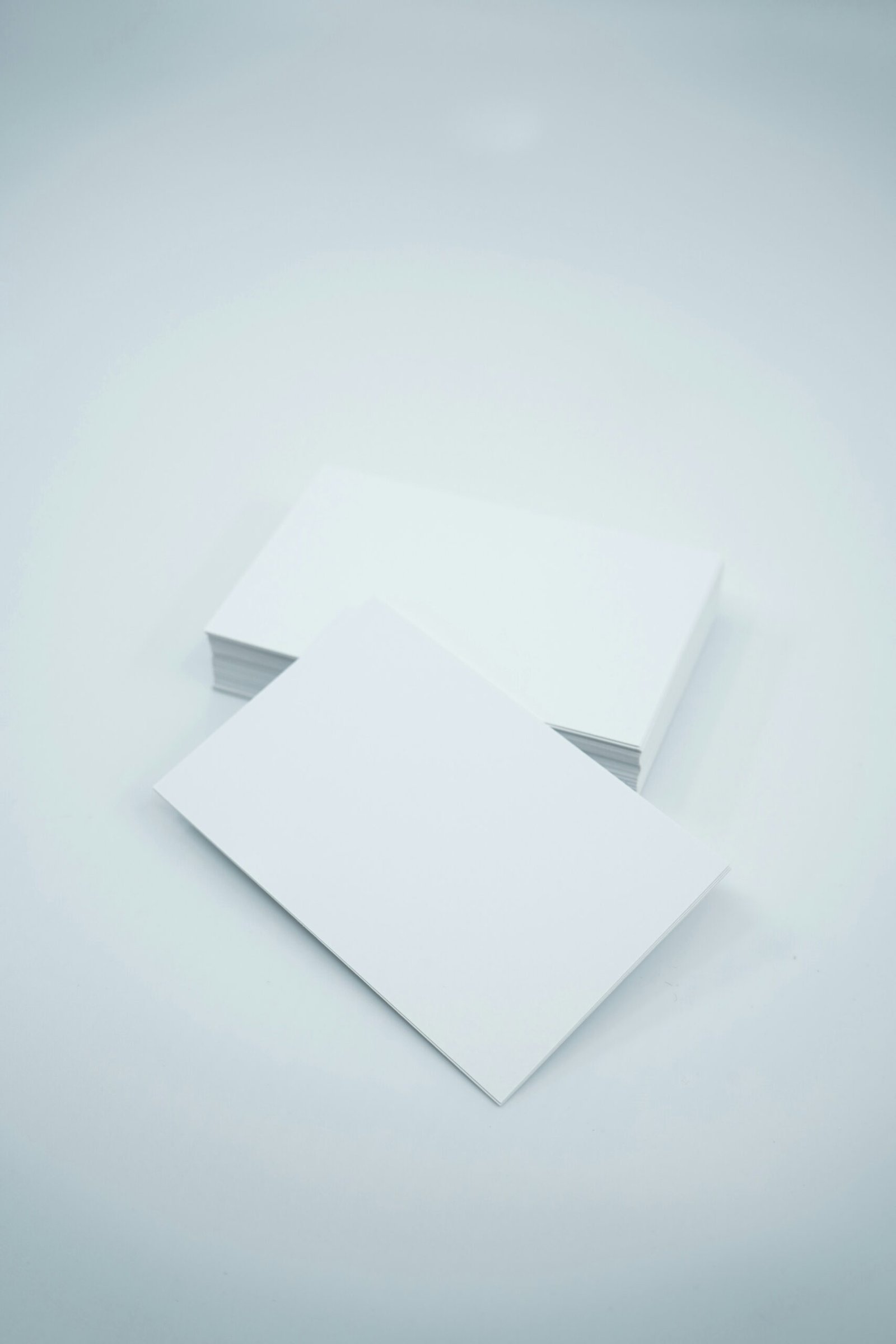 two blank paper sheets on a white background